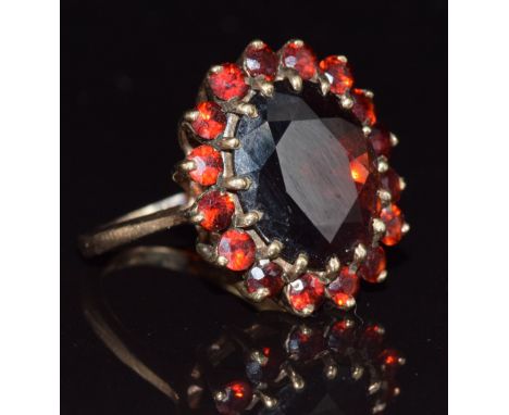 A 9ct gold ring set with a cluster of garnets, 5.5g, size J/K