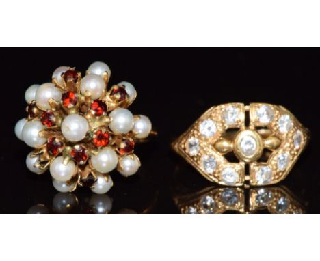 A yellow metal ring marked 21k (3.8g, size O) and a yellow metal ring set with pearls and garnets, 5g, size L