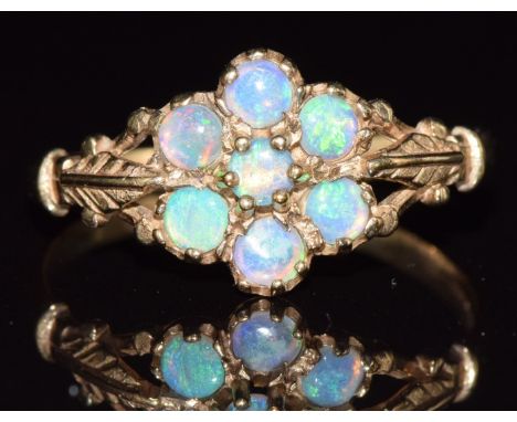 A 9ct gold ring set with opals in a cluster, 1.6g, size R