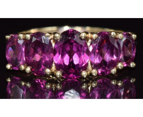 A 9ct gold ring set with five garnets, 2.3g, size J