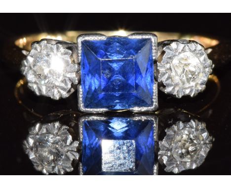 A c1920 18ct gold ring set with a square cut sapphire and two old cut diamonds, 3.5g, size K