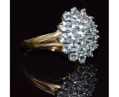 A 9ct gold ring set with a cluster of aquamarines, 3.3g, size N
