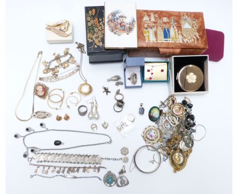 A collection of costume and silver jewellery including white metal charm bracelet, brooches, silver bangle, pendant and ring,