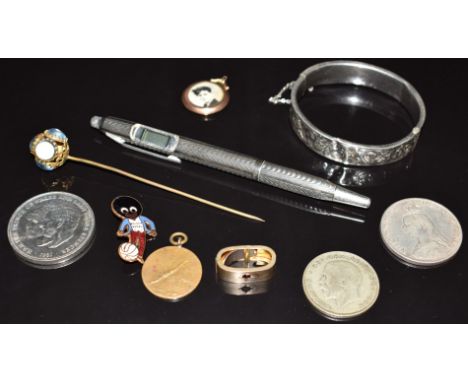 Victorian yellow metal scarf clip set with a ruby, 9ct gold locket, silver bangle, silver pen, coins and Golly badge