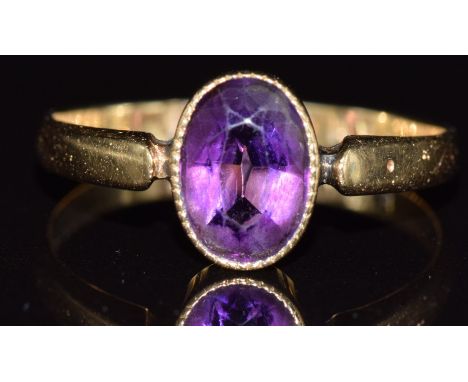 Edwardian 18ct gold ring set with an oval cut amethyst, Birmingham 1909, 2.2g, size N