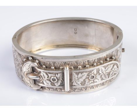A Victorian silver bangle formed as a decorative floral belt buckle. Hallmarked for Birmingham 1884, with 'P&amp;P' makers ma