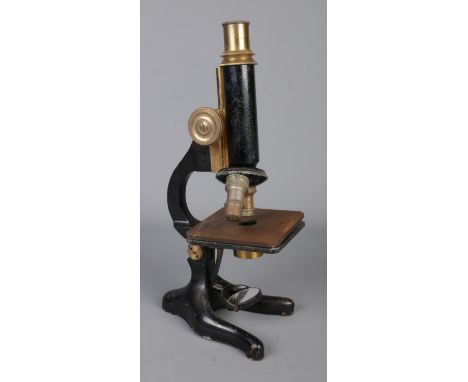 A Philip Harris &amp; Co. Ltd. of Birmingham microscope featuring brass adjustments.