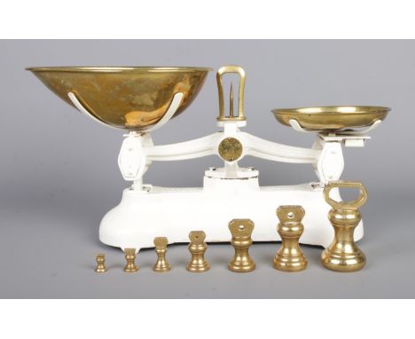 A set of cast metal Libra kitchen scales, with a set of seven brass weights; ¼oz to 1lb.