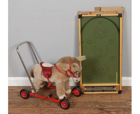 A vintage Merrythought plush push along horse with a boxed Kay London bagatelle board