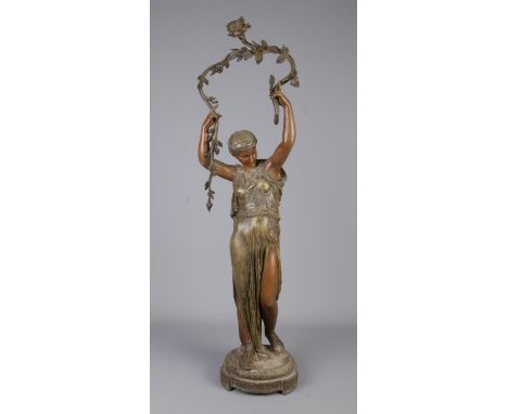 A large bronzed figural table lamp modelled as a maiden. Height 83cm.  Require re wiring.