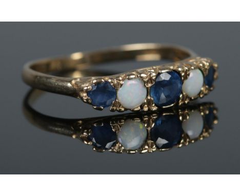 A 9ct gold five stone sapphire and opal ring. Size O½. Total weight: 1.6g