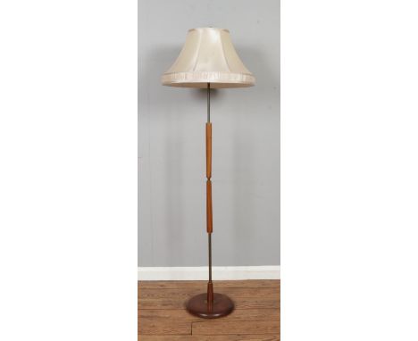 A retro mahogany standard lamp, on circular base. Height: 165cm.