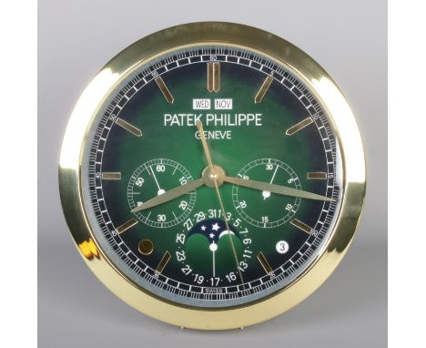 A Patek Philippe watch style wall clock, featuring a gold bezel and green dial.  Quartz movement, working, diameter 40cm.