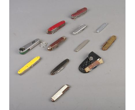 Twelve folding knives and tools, including Diamond Superior,  Golf divot repair kit, Rosterei and Sheffield made examples. CA