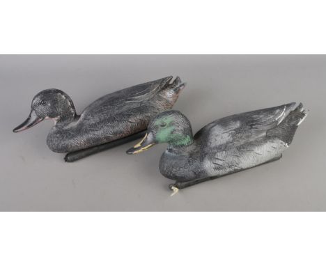 Two vintage painted composite decoy ducks.