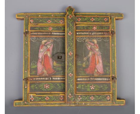 A vintage hand-carved Indian wooden window shutter, with exquisite hand-painted floral motifs and figures dressed in traditio