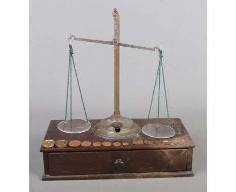 An antique set of travelling Apothecary scales, with Drachm weights, wooden base and drawer. Size W27 x D13 x H30cm.