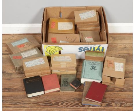 A box of vintage books and Bibles, mostly in original cardboard packaging, including household encyclopaedias and reference b