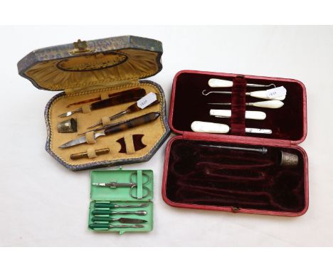 An Art Deco enamelled case travelling manicure set with green bakelite handles, a cased sewing kit with plastic tortoiseshell