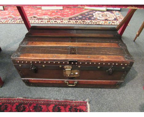 An early 20th Century beech bound canvas trunk with copper and brass studding