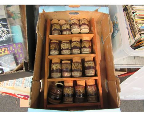 A spice rack with pottery containers made in New Buckenham