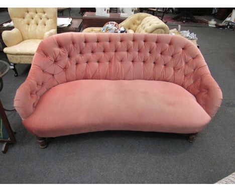 A Victorian button back settee with pink velour, turned front legs, button missing 