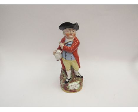 A late 19th Century Staffordshire Toby jug, holding pipe and ale jug, 28cm tall
