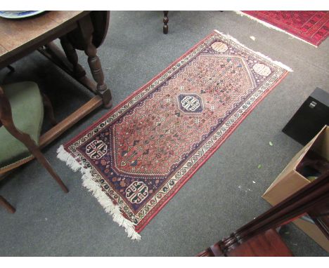 A small Eastern wool runner rug with central panel of flora and fauna design, tasselled ends, 160cm x 69cm