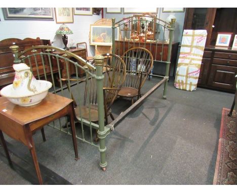 A Victorian brass and iron bed frame with side irons on ceramic castors painted in "Harrods" green