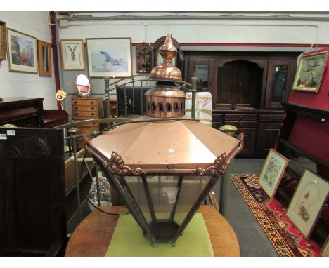A copper lamp with plastic panels, one missing