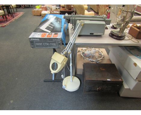 A floor-standing angle poise lamp with magnifying glass 