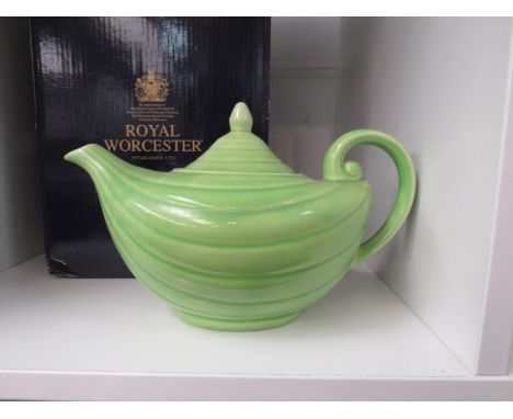 A boxed Royal Worcester figure of the Queen and a green teapot in the form of an Aladdin's lamp (2)