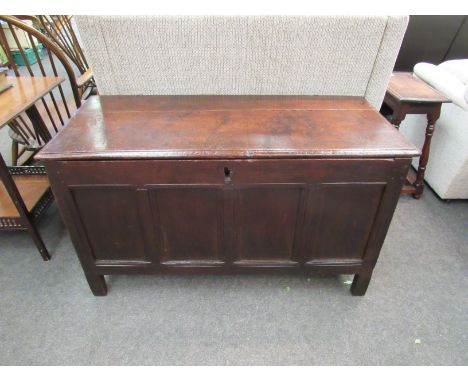 A 17th Century four panel oak coffer the hinged lid over stile feet. 64cm x 112cm x 51cm
