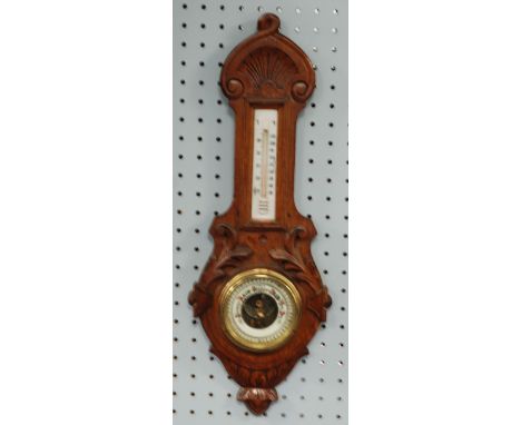 EARLY 20th CENTURY CARVED OAK BANJO CASED ANEROID BAROMETER, with thermometer to the trunk, 22" (56cm) high