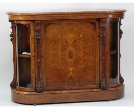 VICTORIAN BURR WALNUTWOOD AND MARQUETRY INLAID BOW FRONTED CREDENZA, the moulded shaped top above a central panelled cupboard