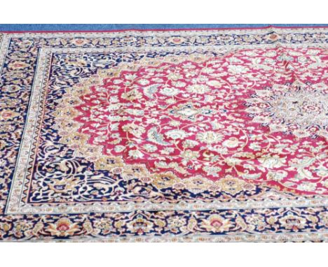 MODERN MACHINE MADE EASTERN CARPET ON RED GROUND, 79" x 107 ½"
