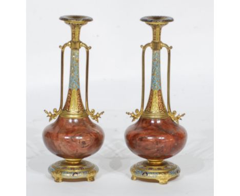 PAIR OF LATE 19th CENTURY FRENCH ORMOLU MOUNTED VEINED RED MARBLE CHAMPLEVE ENAMEL DECORATED TWO-HANDLED VASES, on circular b