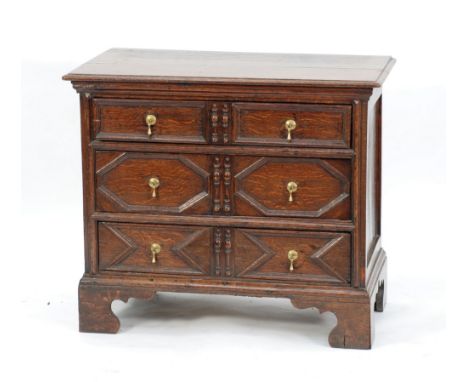 LATE 17th CENTURY OAK SMALL CHEST OF DRAWERS, the moulded oblong top above three geometric moulded long drawers with split tu