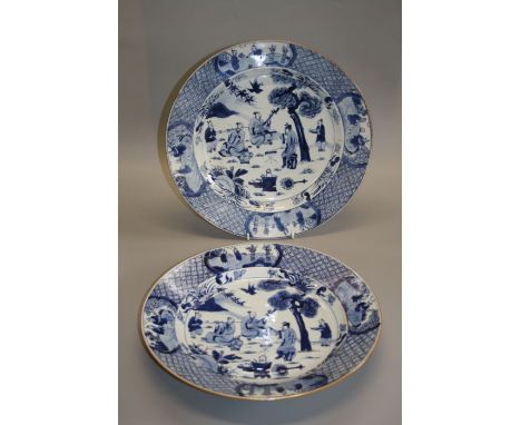 A pair of large blue and white circular dishes, Qing dynasty, Kangxi period. The interior painted with a group of musicians b