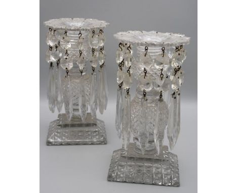 A pair of early Victorian cut lead crystal single light table lustres, each with flared rim pineapple column and rectangular 