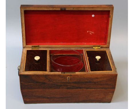 A 19th century rosewood tea caddy of sarcophagus form with boxwood escutcheon and stringing, cast flowering basket ring handl