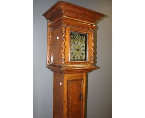 Henry Burges lantern clock in oak case. A thirty hour lantern clock with 6 1/2 hour square dial winged cherub spandrels singl