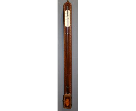 An early 19th century mahogany stick barometer, crossbanded case with patera inlaid cistern cover, ivory plates and vernier s