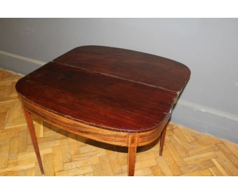 An early 19th century mahogany supper table, D shape reeded fold over top above satinwood and ebony banded frieze, on square 