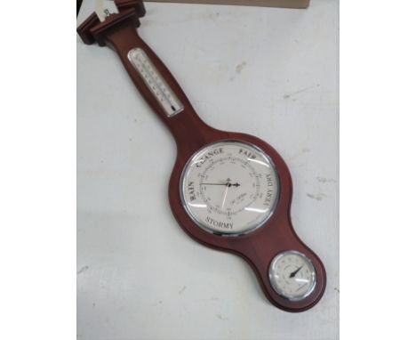 A Modern Aneroid barometer. Banjo form in mahogany case. 
