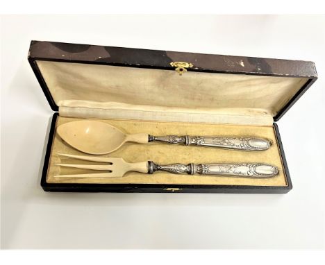 A Pair of French Salad Servers. Circa 1910. With silver plated handles. The fork handle damaged. Fitted case. 
