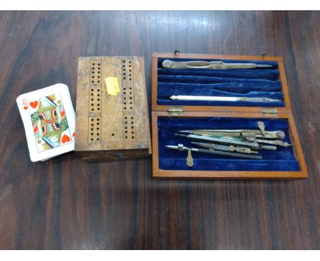 A wooden box with cards and a geometry set 