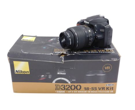 A Nikon D3200 camera, with lens, box and some accessories. 