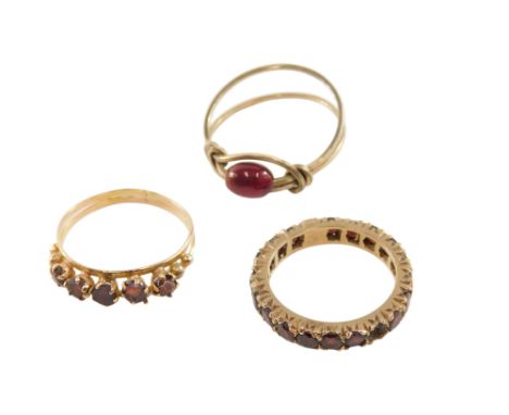 A 9ct gold and garnet full eternity ring, one stone lacking, size N, garnet five stone ring, in a claw setting, in yellow met
