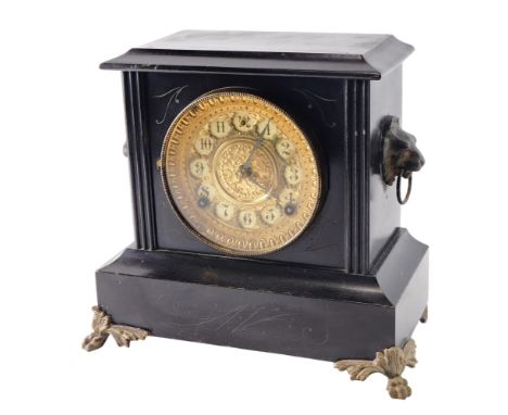 A late 19thC ebonised and gilt metal mantel clock, the pressed dial with Arabic numerals, flanked by lion masks, 27cm high.